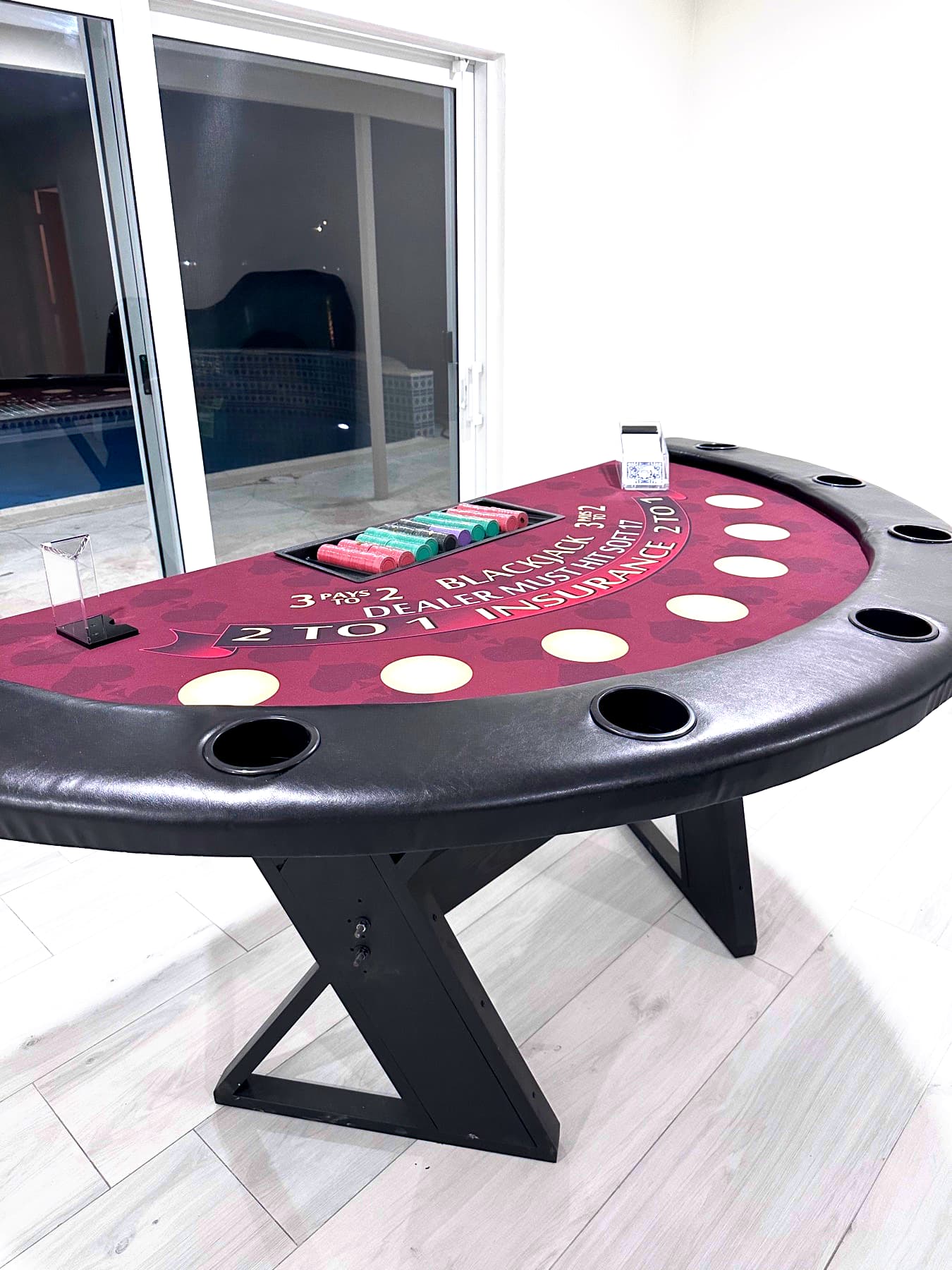 Hand-built burgundy blackjack table by a window