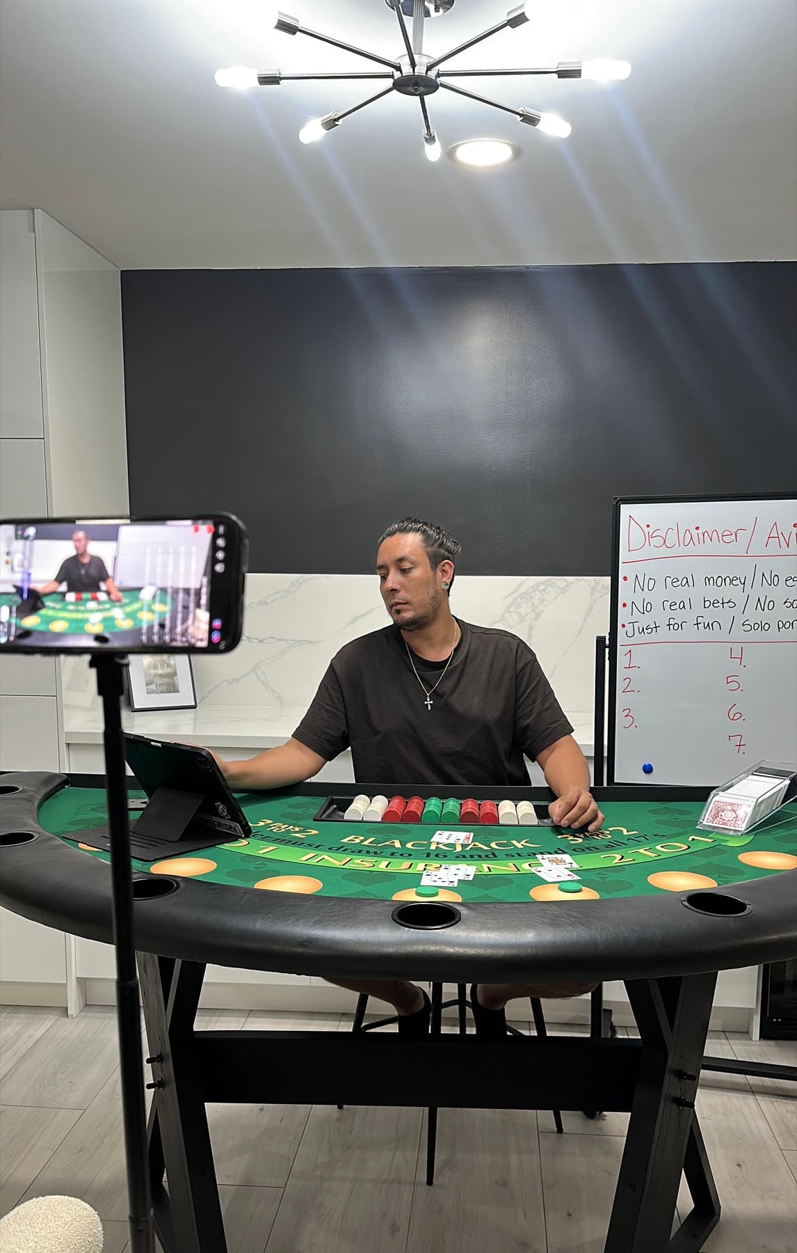 Joshua at a blackjack table recording a dealer training video