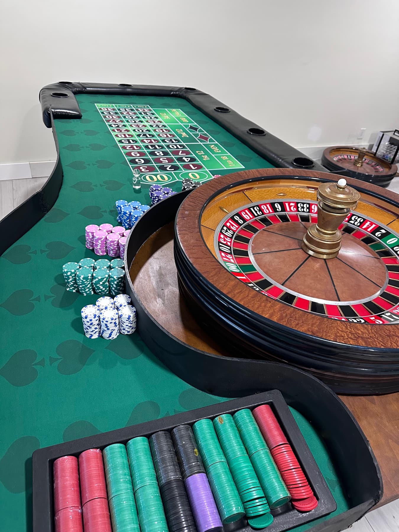 Hand-built roulette table with a John Huxley wheel and racks of colored chips