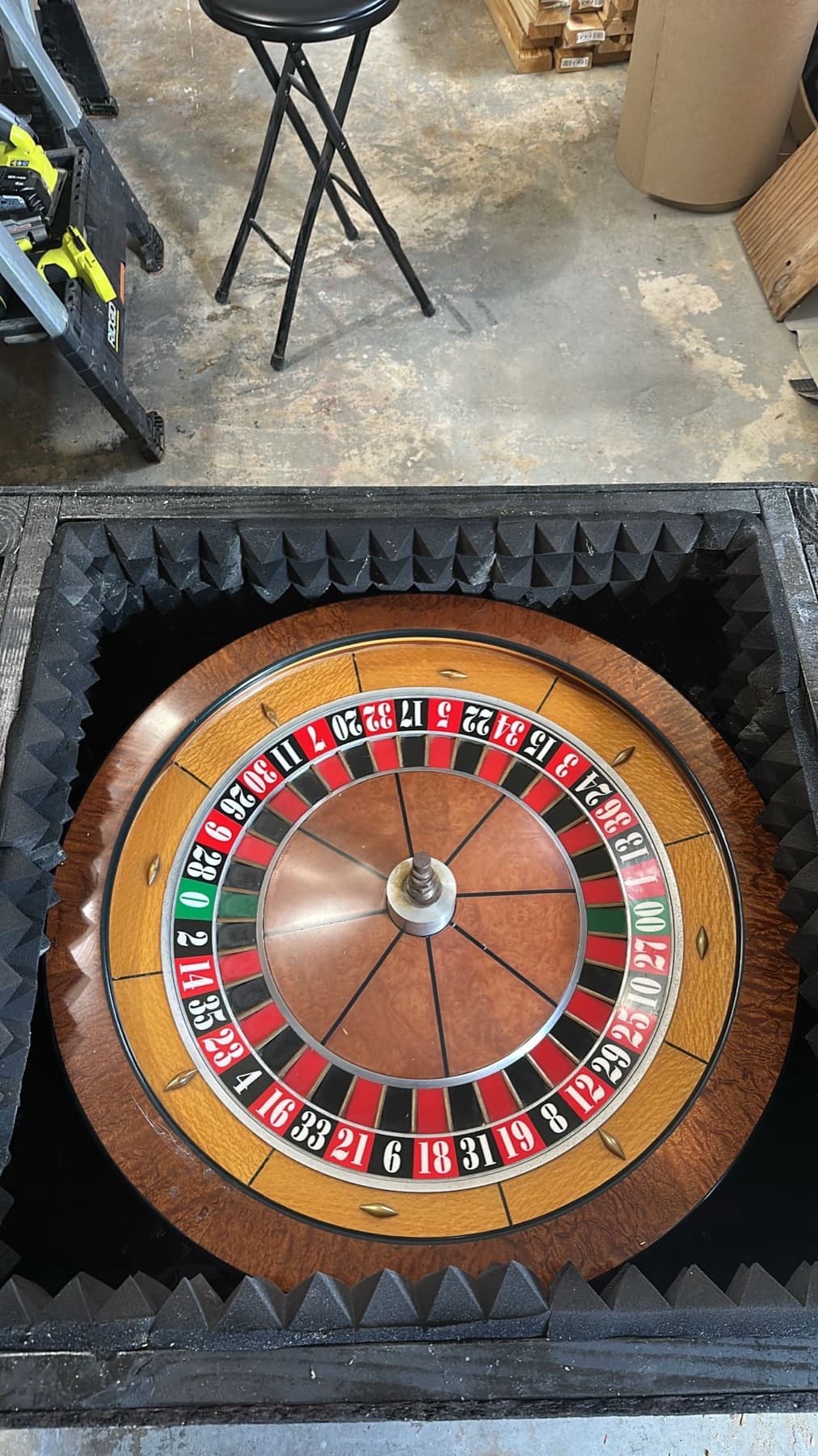 A John Huxley roulette wheel resting in its padded flight case